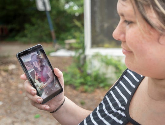 Amber Bonal holds a photo of her 11-year-old daughter Alyssa Bonal outside their home in Pensacola on Wednesday, May 19, 2021.  Amber explains that Alyssa’s quick thinking and action thwarted yesterday's kidnapping attempt.
