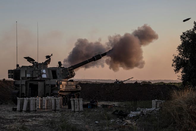 An Israeli artillery unit fires toward targets in Gaza Strip, at the Israeli Gaza border, on May 18, 2021.