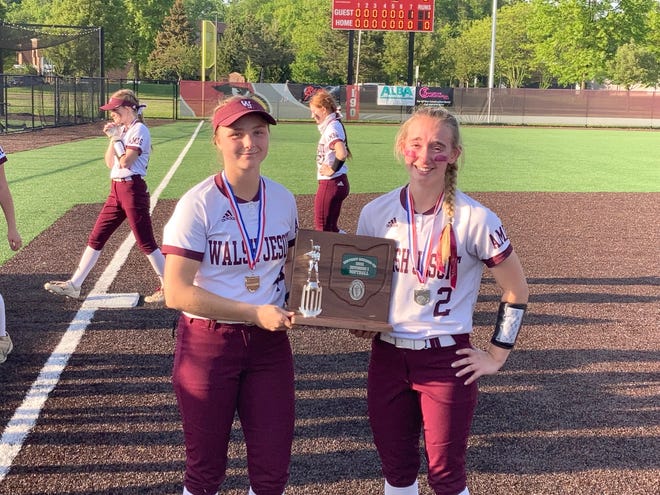 Walsh Jesuit captains Maddie Schmeiser (left) and Emma Barnes show off the district runner-up trophy Wednesday at Mentor.
