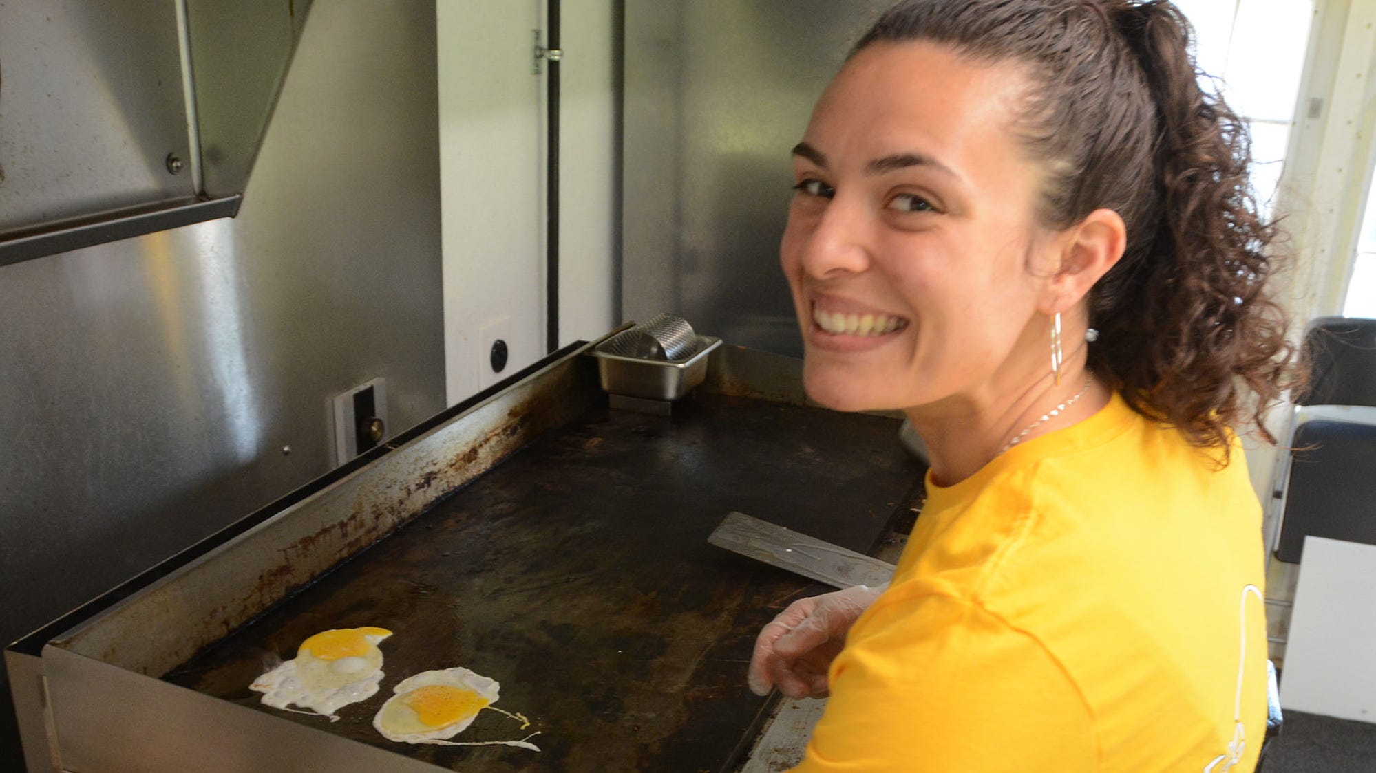 Hannah Dupuis prepares an egg and cheese sandwich at Egg and Cheese, her business that recently opened on Route 32 in Franklin.