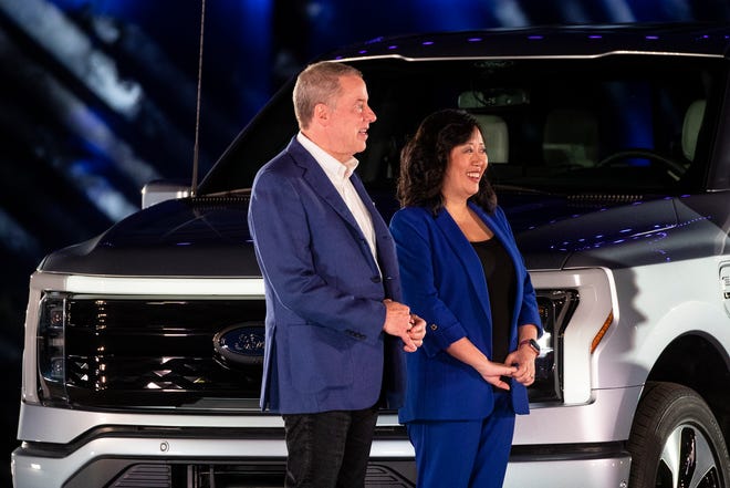 Bill Ford, who now goes by executive chair rather than chairman, stands next to Linda Zhang, chief engineer of F-150, after Ford Motor Co. unveils the electric F-150 Lightning at its World Headquarters in Dearborn on May 19, 2021.