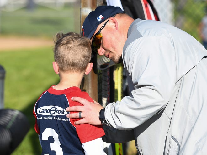 Warren Little League Twins' assistant coach Josh Terhune comforts a player after a strike-out during a game against the Pirates on Wednesday, May 12, 2021 at the Warren Little League fields in Indianapolis, Ind. Warren Little League, which goes back at least 60 years, is ending after this season. The baseball fields, located on Brookville Road, will be torn out and used for football. 