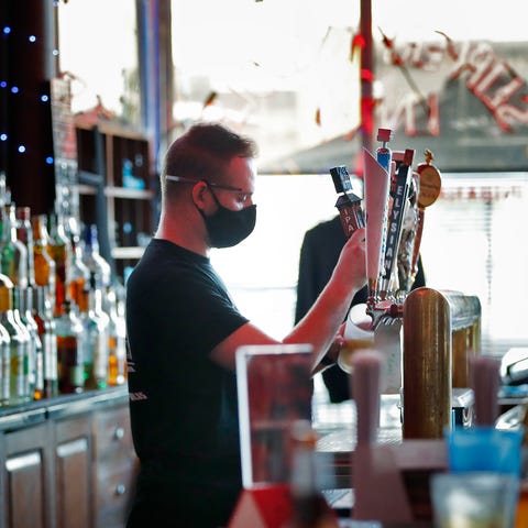Zach Perkins pours a beer at Slippery Noodle Inn, 