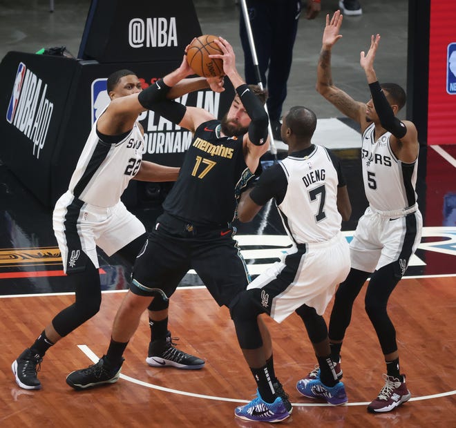 Memphis Grizzlies center Jonas Valanciunas is triple teamed in the paint by San Antonio Spurs players Rudy Gay, from left, Gorgui Dieng and Dejounte Murray during their play-in tournament game at the FedExForum on Wednesday, May 19, 2021.