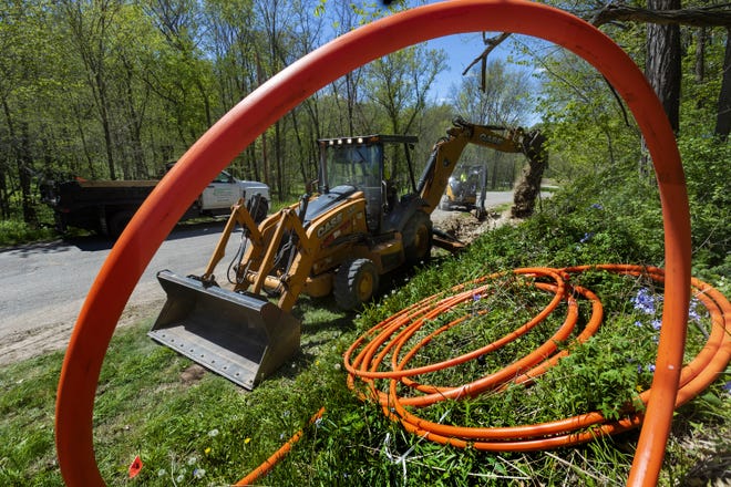 Workers for Eau Claire-based Underground Systems Inc. bury fiber-optic cable in Hager City. A similar system by TDS Telecom is already under construction in Brookfield, Wis., as the company initiates a plan to install its growing work in neighboring New Berlin.