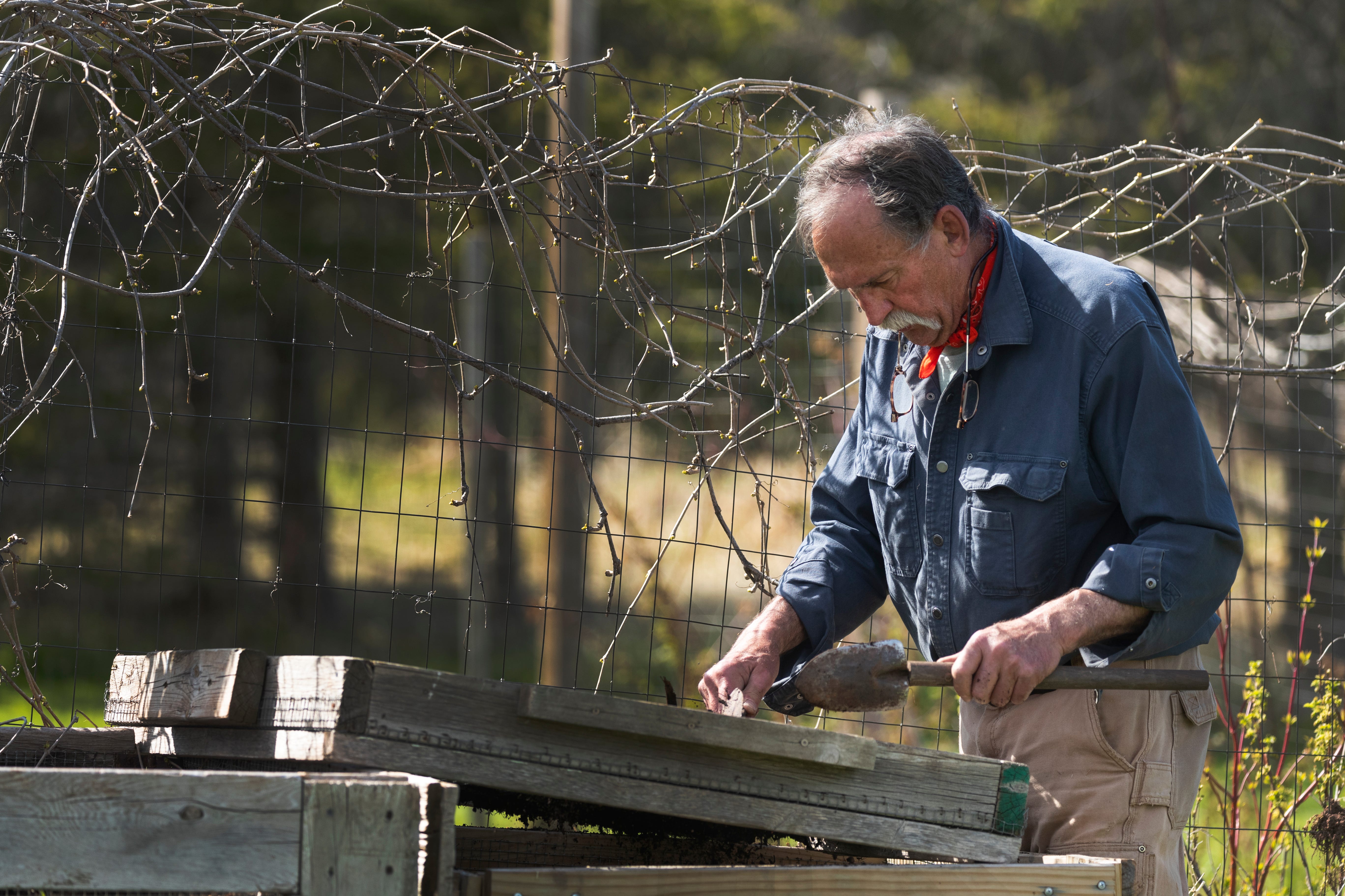 Michael Spencer tends to his garden at his home in the Town of Cloverland in Douglas County. He spearheaded the campaign to subsidize the cost of bringing fiber-optic cable to the area.