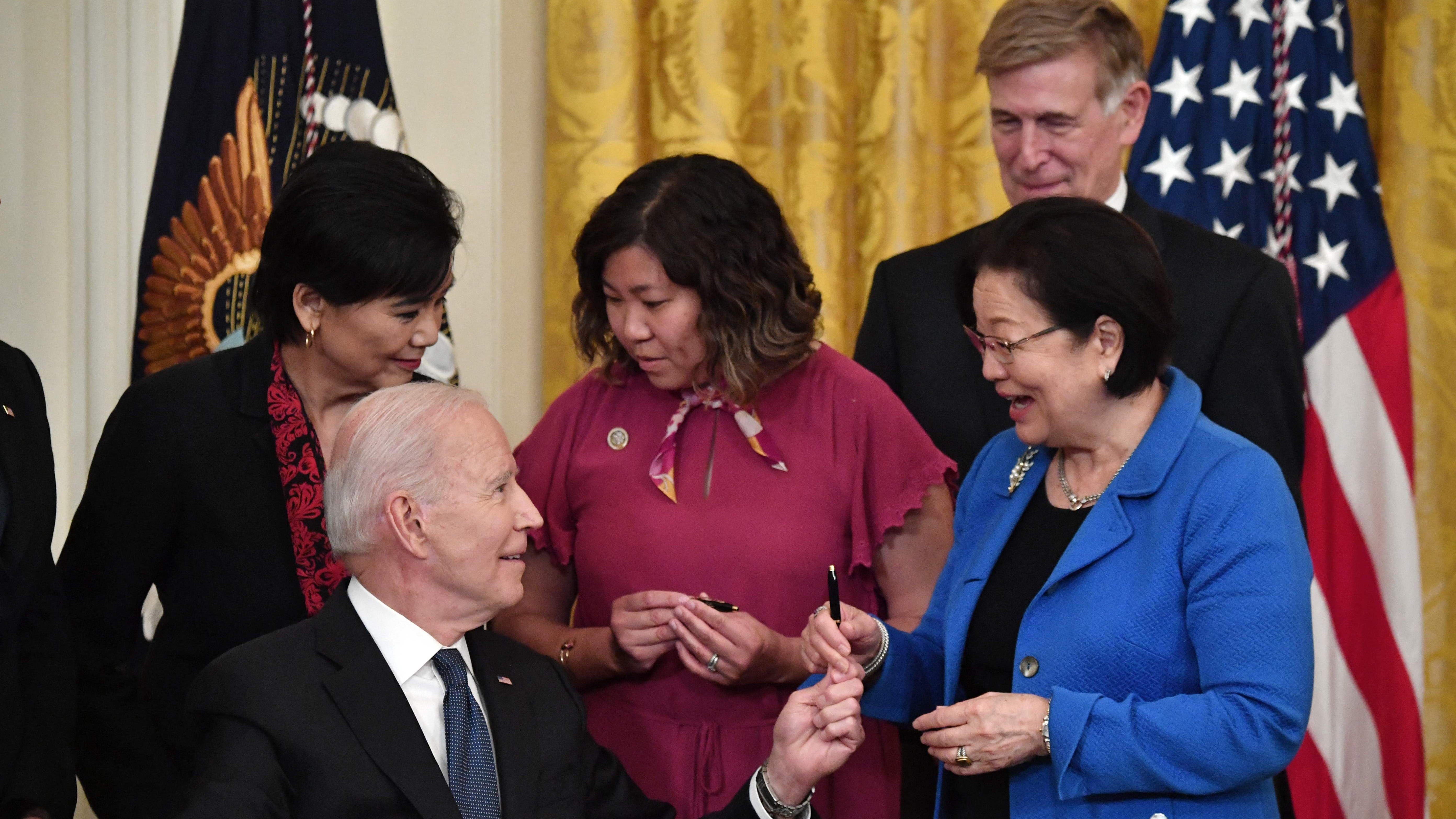 President Joe Biden hands over a pen to Sen. Mazie Hirono, D-Hawaii,  after signing the Covid-19 Hate Crimes Act, in the East Room of the White House in Washington, D.C., on May 20, 2021.