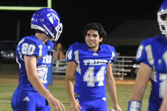 Chuy Gonzales, center, speaking to teammate Wyatt Knippa during a game last season, said he hopes to have the option of playing for a UIL school if a piece of legislation is signed into law by Gov. Greg Abbott later this month.