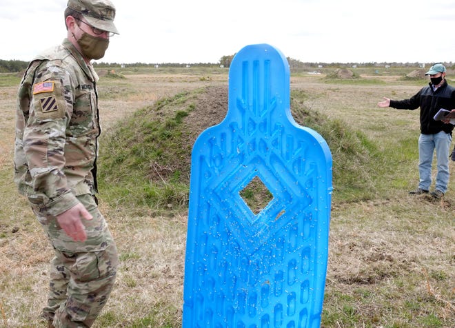 Major Alexander McDouough, left, and Jake McCumber, of natural resources and military training lands management, talk about the targets and berm behind it at Sierra range at Joint Base Cape Cod in April. Should the Environmental Management Commission approve the machine-gun range project, the Massachusetts National Guard will advertise, award and implement a species protection plan before beginning construction, McDonough said at Thursday's meeting.