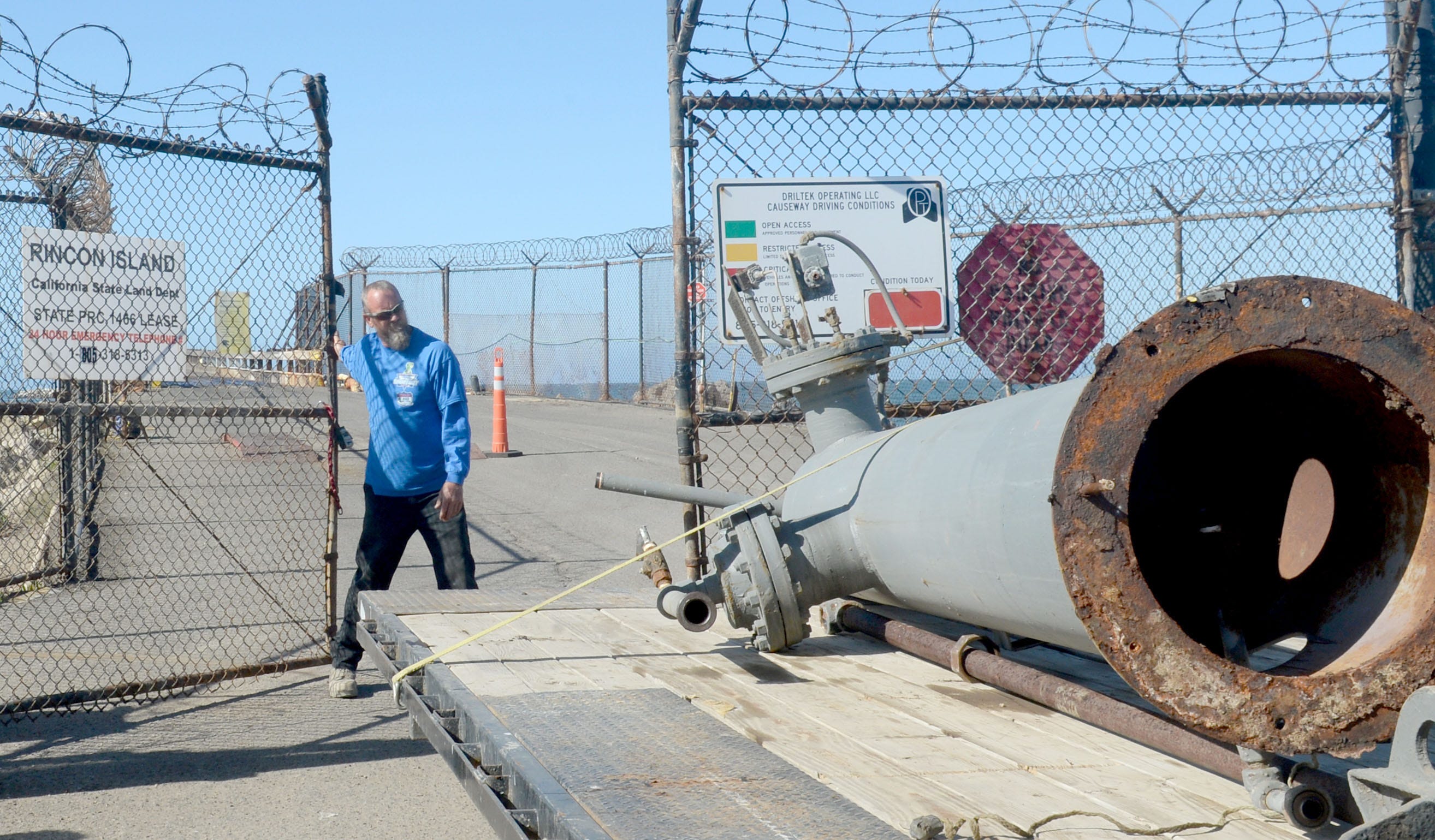 Larry Brown, an employee of Driltek, transports old equipment off Rincon Island near Mussel Shoals after the island's oil wells were plugged and abandoned.