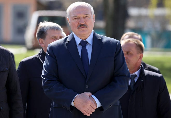 In this April 26, 2021, photo, Belarus President Alexander Lukashenko, accompanied by officials, attends a requiem rally on the occasion of the 35th anniversary of the Chernobyl disaster in the town of Bragin, Belarus.