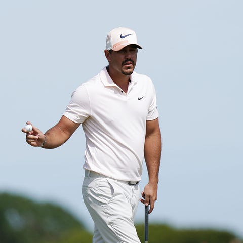 Brooks Koepka reacts following his putt on the sev