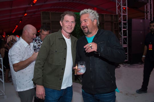 Celebrity chefs Bobby Flay, left, and Guy Fieri chat during the annual South Beach Wine & Food Festival in Miami Beach, Fla.