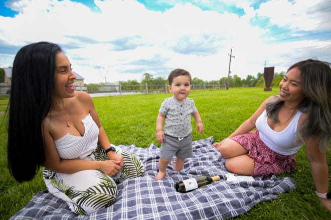 Families, couples and friends gather at Buckingham Valley Vineyards, sipping wine and snacking on cheese and crackers as a musician played acoustic tunes, against a backdrop of rolling vineyards.