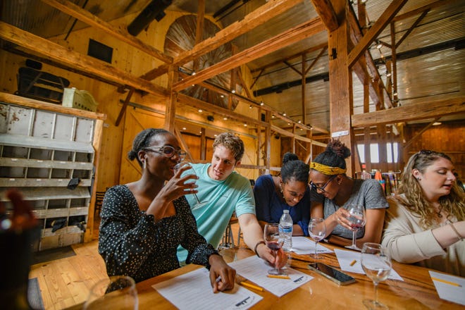 Customers enjoy the wine and the atmosphere of Bishop Estate Vineyard and Winery's historical barn & our "coop" area, which is one of many tasting areas on the Perkasie farm.