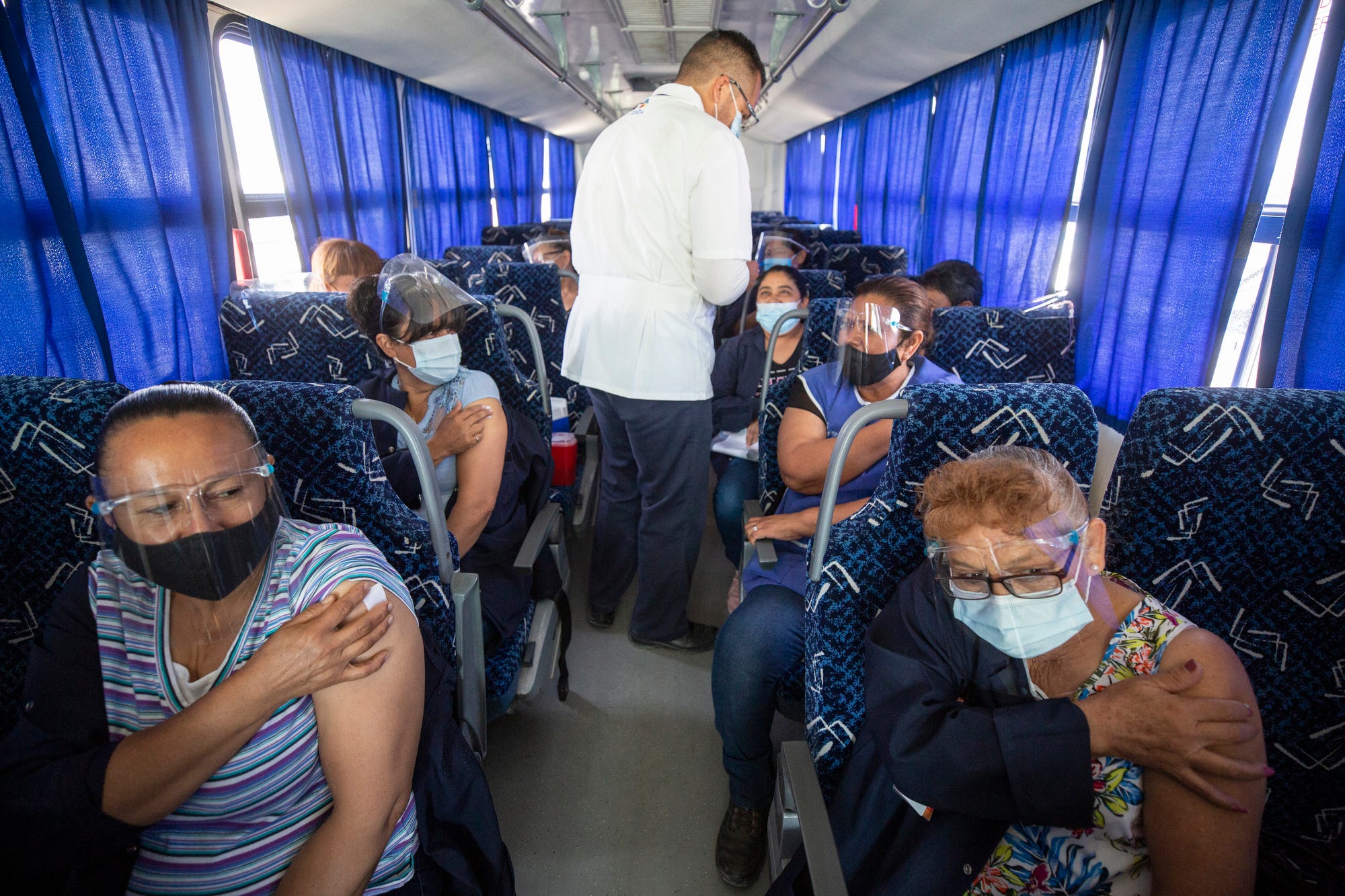 Chihuahua state public health nurse Jesus Morales administers COVID-19 vaccines to factory workers that were bused in to El Punto en el Chamizal during a vaccination drive for 50-to-59 year-olds on May 24, 2021, in Juarez.