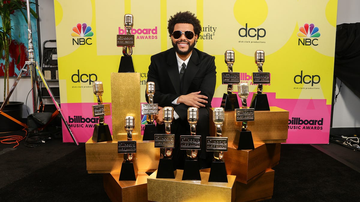 The Weeknd, winner of the Top Artist Award, Top Male Artist Award, Top Hot 100 Artist Award, Top Radio Songs Artist Award, Top R&B Artist Award, Top R&B Album Award, Top Billboard 200 Album Award, Top Hot 100 Song Presented by Rockstar Award, Top Radio Song Award, and Top R&B Song Award poses backstage.