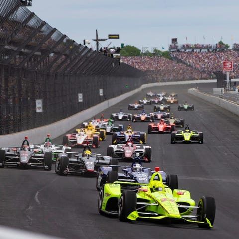 Driver Simon Pagenaud leads the pack at the start 
