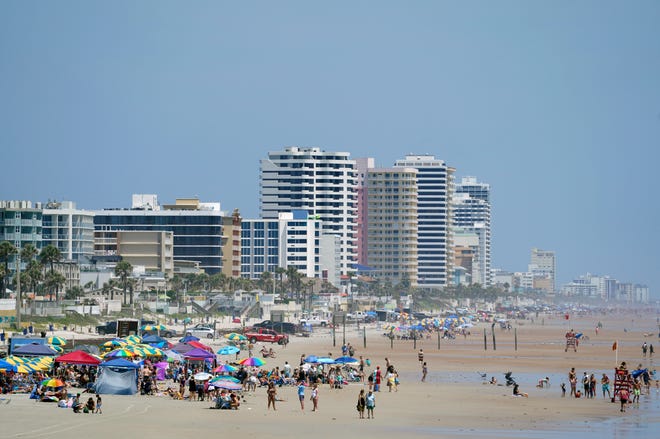 Beachgoers take to the sand this week in Daytona Beach. Hoteliers expect t be at capacity for the Memorial Day weekend holiday, kicking off what is anticipated to be a busy summer season.