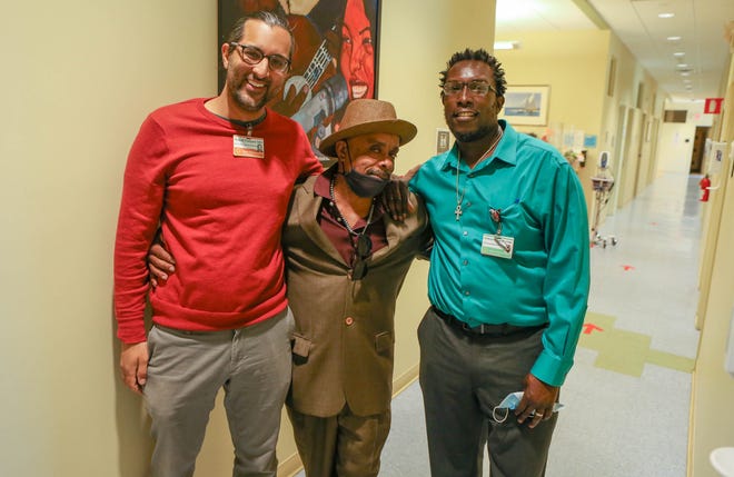 The Transition Clinic's Dr. Rahul Vanjani, left, and community health worker Anthony Thigpen, right, have worked together to help client Theodore C. Wright, a repeat offender with a history of substance abuse, homelessness and medical conditions.