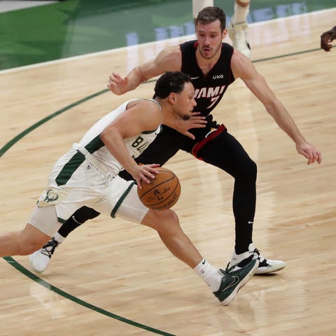 Bucks guard Bryn Forbes drives past Miami Heat gua