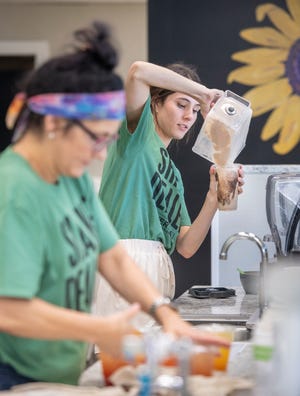 Audrea Dawn Cooley, left, and Makayla Harigel prepare orders at Everyday Nutrition at 4421 Bayou Boulevard in Pensacola on Tuesday, May 25, 2021.