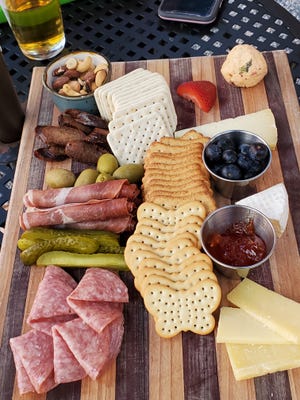 The charcuterie boards are piled with fresh meats and cheeses, including Thomasville's Sweet Grass Dairy cheeses and smoked Bradley's Country Store sausage.