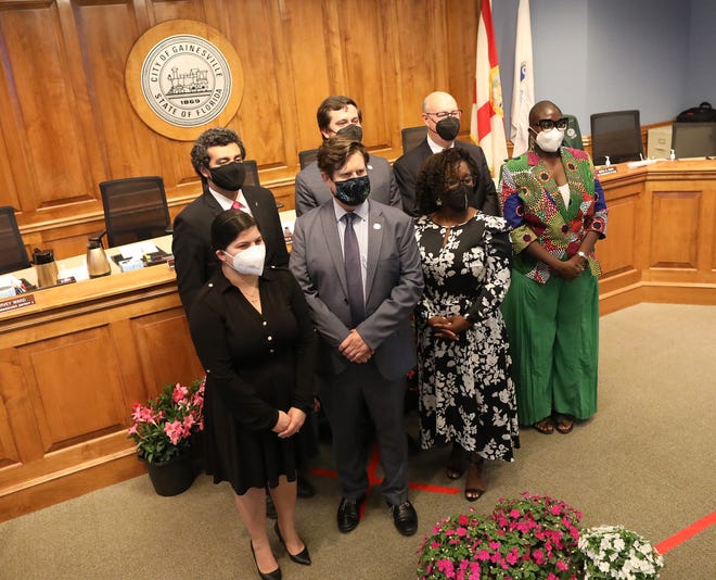 Gainesville City Commissioners, front row left to right, Reina Saco, Mayor Lauren Poe, new Commissioner Desmon Duncan-Walker, Gail Johnson and back row left to right, David Arreola, Adrian Hayes-Santos and Harvey Ward, pose for a picture after the swearing-in ceremony on May 6th. Johnson recently announced her resignation, which resulted in a special election to fill her seat.