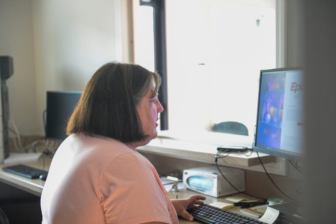 Kathleen Cotten, a nurse practitioner, works on a computer at the Bon Secours Legacy Early College Health Center on May 26, 2021. 