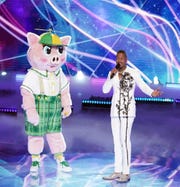 "Masked Singer" contestant Piglet with the show's host, Nick Cannon.