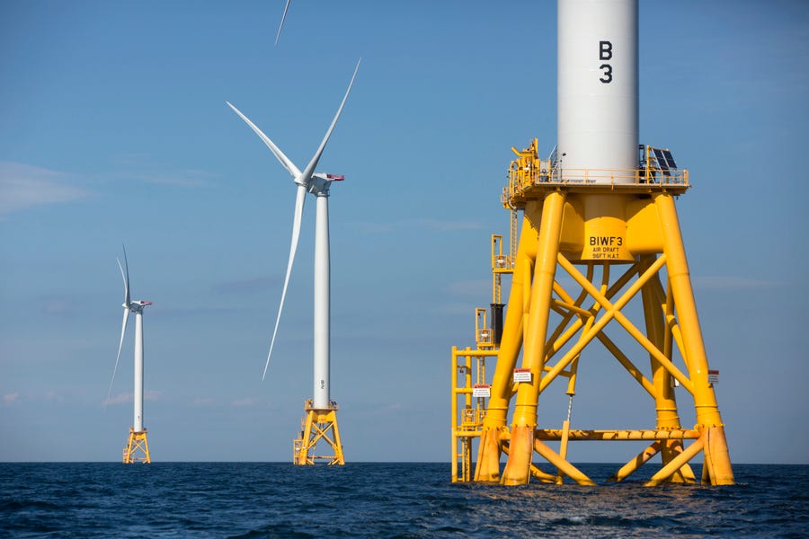 Three of Deepwater Wind's five turbines stand in the water off Block Island, Rhode Island, the nation's first offshore wind farm. California and the federal government have agreed to open up areas off the central and northern coasts to massive wind farms.
