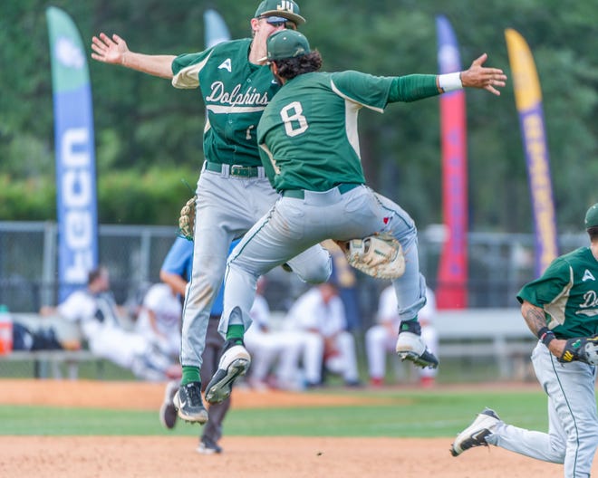 Jacksonville University third baseman Jackson Grabsky (17) celebrates with first baseball Christian Coipel (8) after the Dolphins beat Liberty 2-1 last year in the first game of the ASUN baseball tournament at the University of North Florida. JU is the defending champion when the ASUN tournament begins on May 24 in Fort Myers.