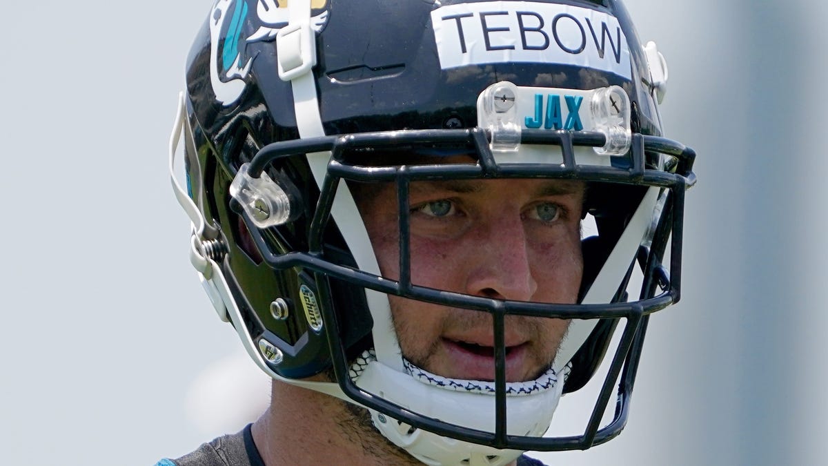 Tim Tebow looks on during Jaguars OTAs.