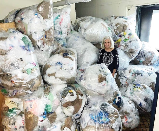 This is a photo of Barbara Ferrell with about 500 pounds of plastic bags intended for NexTrex, the recycling program sponsored by Trex decking company. Trex has promised a free park bench to Jackson Square in exchange for the plastic