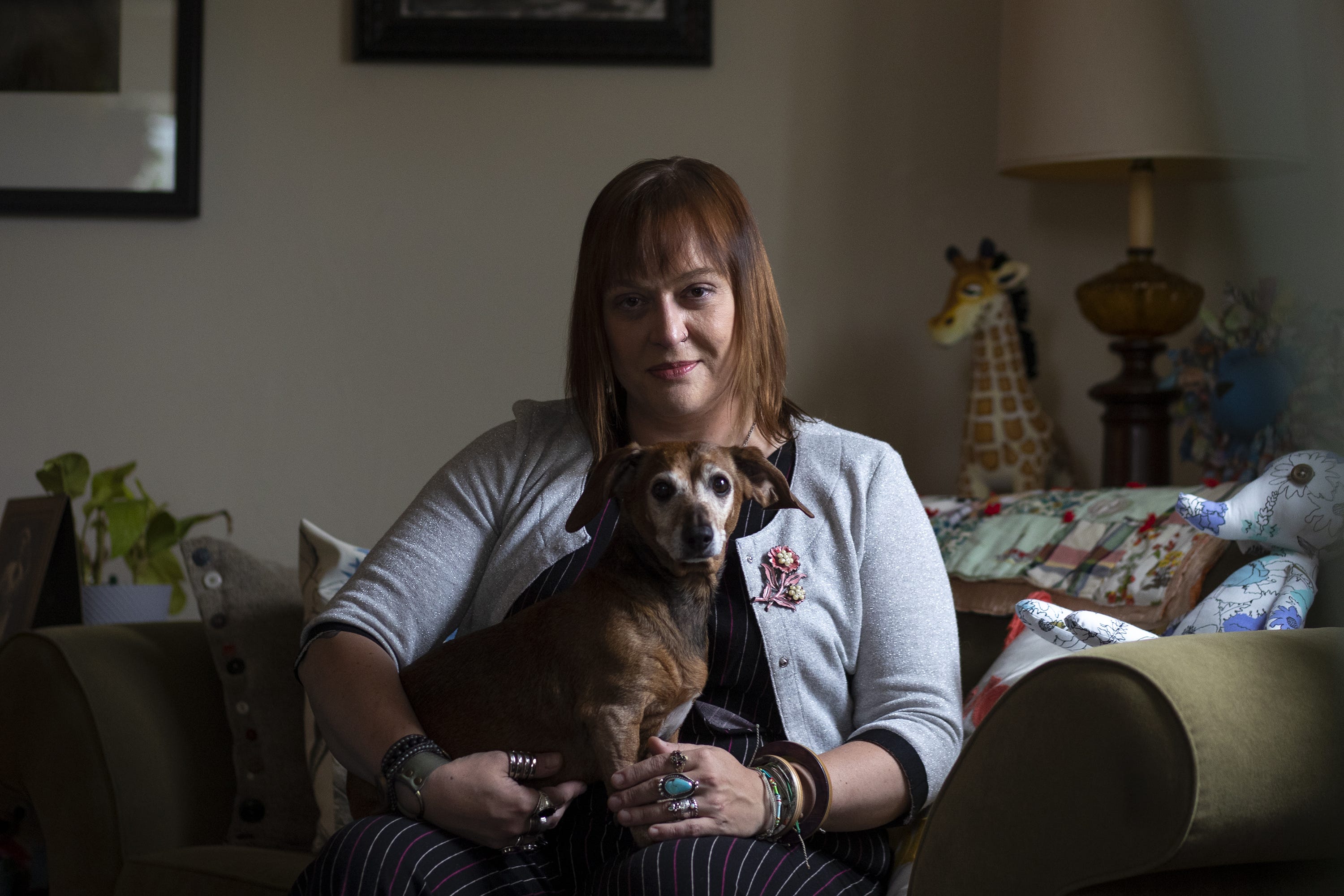 Stacey Burkhart, head of SAGE Green Bay, and business owner of Eight Trees poses for a portrait with her dog Daisy in her apartment, Thursday, May 27, 2021, Pulaski, Wis. Samantha Madar/USA TODAY NETWORK-Wisconsin