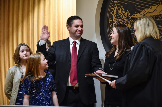 In this Jan. 4, 2021 file photo, Montana Attorney General Austin Knudsen is sworn into office, inside the Montana State Capitol in Helena, Mont. Republican legislative leadership approved a special counsel investigation into reports that Knudsen used state resources, including law enforcement, to harass and intimidate physicians and staff at St. Peter’s Hospital in Helena.