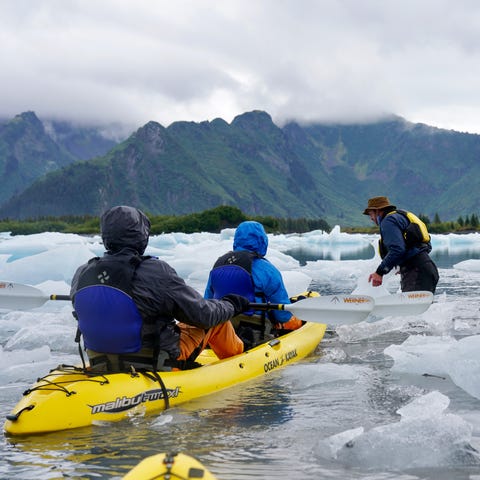 Kayakers paddle through icebergs in Alaska's Kenai