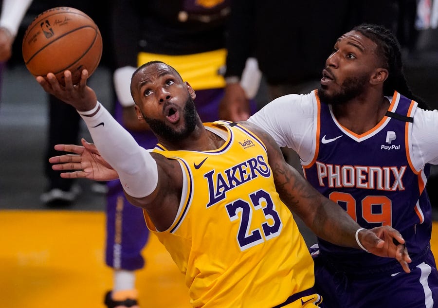 First round: Lakers forward LeBron James (23) drives to the hoop past Suns defender Jae Crowder (99) during the second half of Game 3.