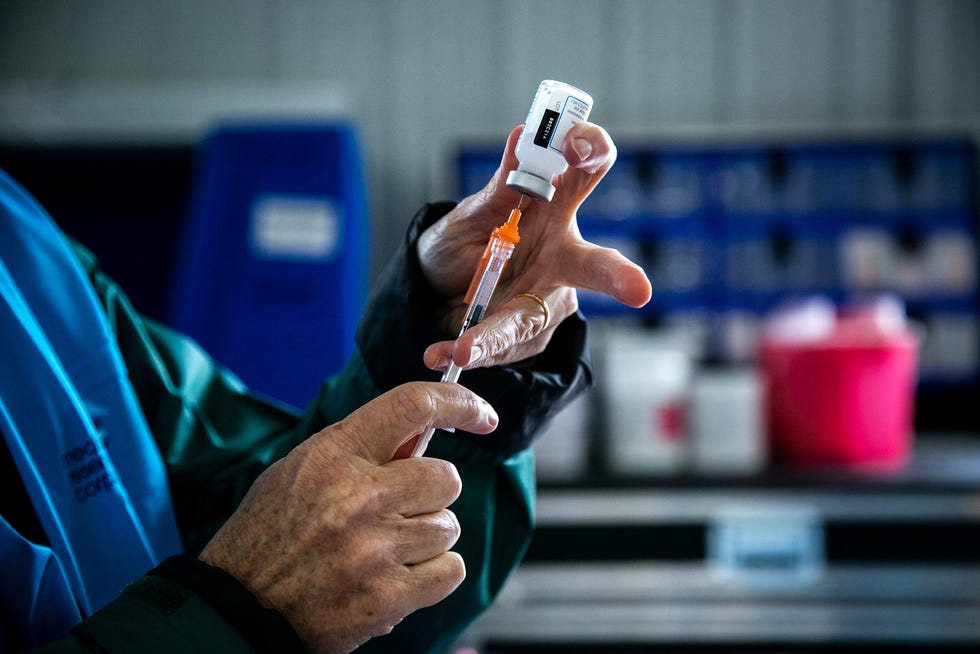 Kelly Smith, a Johnson County Public Health nurse, draws a dose of the Moderna COVID-19 vaccine during a free food box and vaccine clinic drive-thru event, Thursday, May 27, 2021, at the Johnson County Fairgrounds in Iowa City, Iowa.
