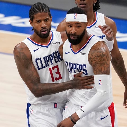 Paul George and Marcus Morris celebrate as they le