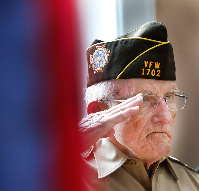 U.S. Army veteran John Thompson, of Veterans of Foreign Wars Post 1702, salutes as the national anthem is played during Braintree's Memorial Day observances at town hall Sunday, May 30, 2021.