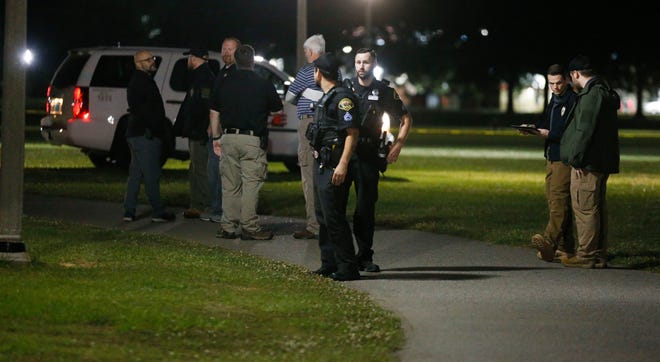 Tuscaloosa Police officers and investigators from the Violent Crimes Unit investigate the scene of a homicide in Snow Hinton Park Saturday night, May 29, 2021. [Staff Photo/Gary Cosby Jr.]