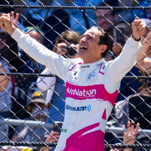 Helio Castroneves celebrates after winning the 105