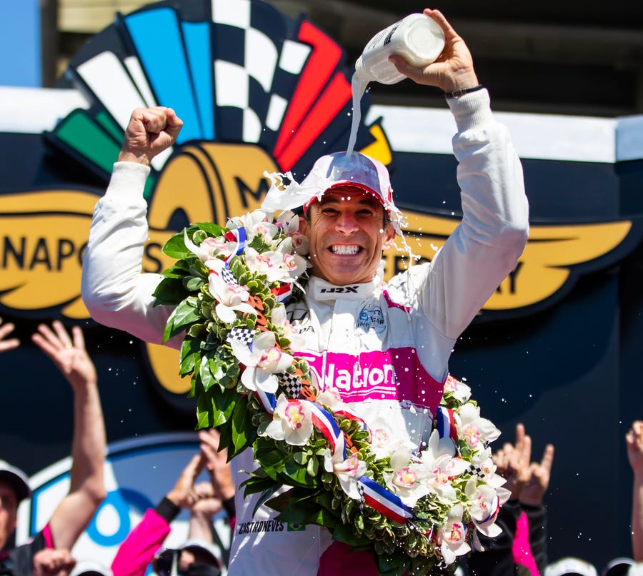 Helio Castroneves celebrates as he dumps milk on himself after winning the 105th Indianapolis 500.