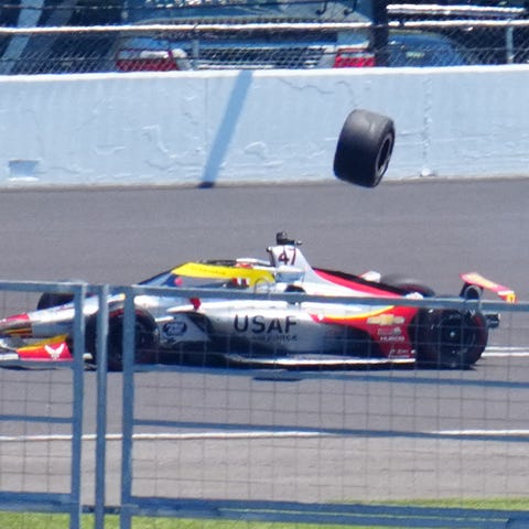 Conor Daly, left, hits the tire that flew off of G