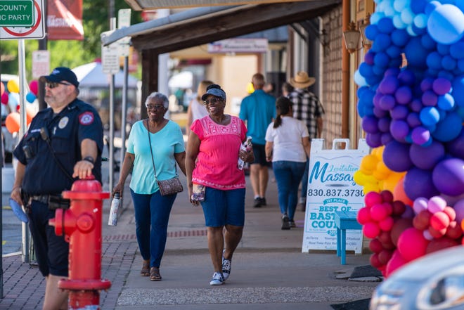 Two women walk in Downtown Bastrop during the city's first Summer in the City event in 2019. The 2021 edition of Summer in the City, scheduled for this Saturday, will highlight Bastrop's new-look Main Street and its improved sidewalks.