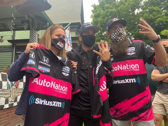 Kimmy and Jameson Terzini pose with four-time Indianapolis 500 winner Helio Castroneves and the autographed team shirts he gave them.