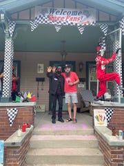 Helio Castroneves and Jameson Terzini pose on Terzini's front porch after Castroneves' fourth Indianapolis 500 win.
