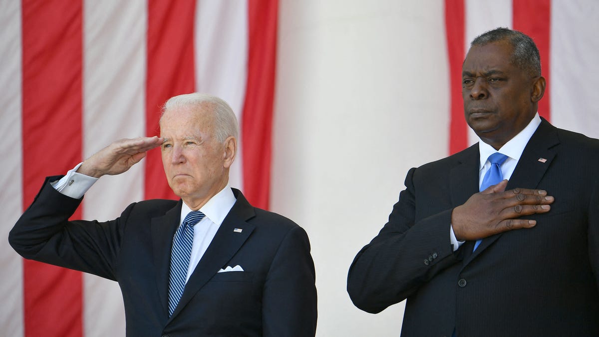 President Joe Biden salutes next to Defense Secretary Lloyd Austin at the 153rd National Memorial Day Observance at  Arlington National Cemetery on May 31, 2021.