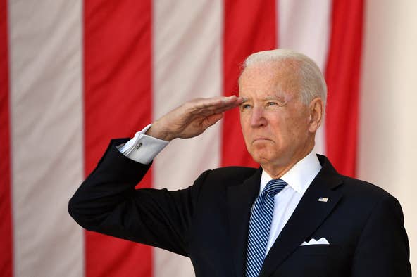 President Joe Biden salutes before delivering an address at the 153rd National Memorial Day Observance at  Arlington National Cemetery on Memorial Day in Arlington, Va on May 31, 2021.